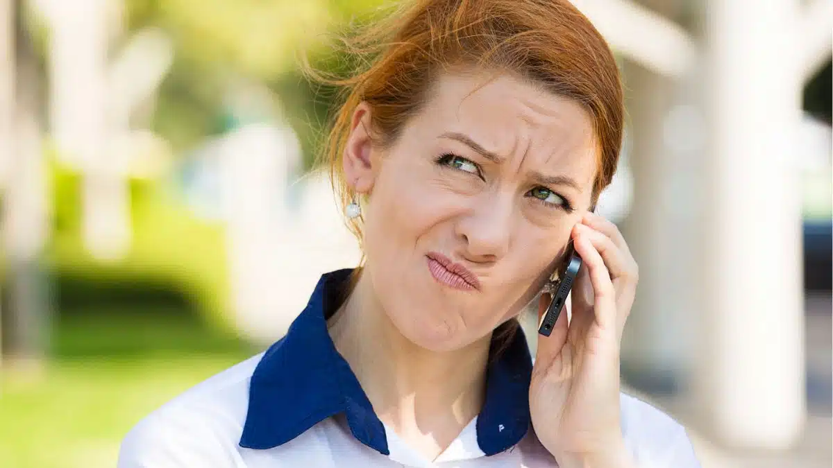 woman stressed on the phone in the parking