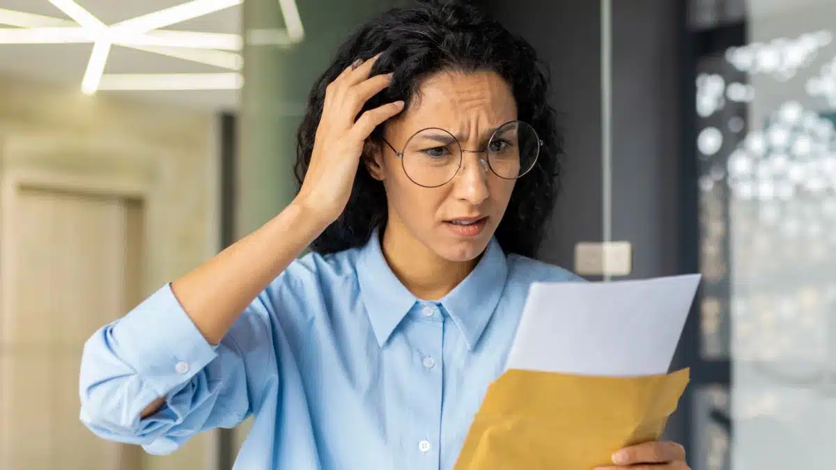woman wearing glasses staring at document