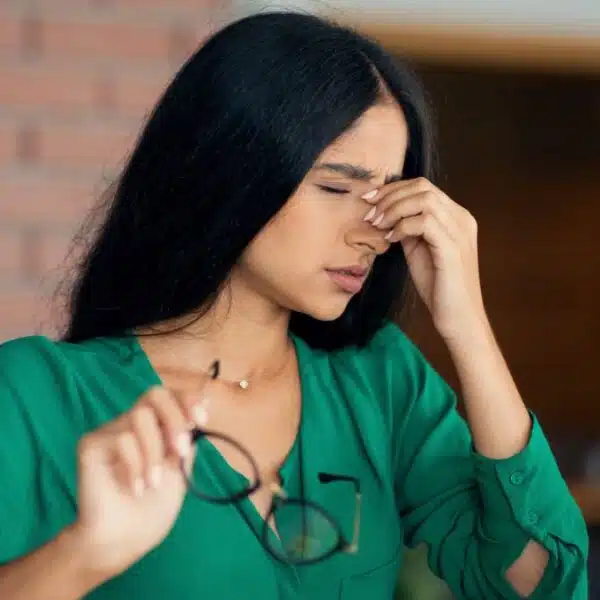 woman with a headache on laptop