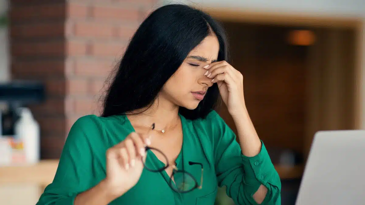 woman with a headache on laptop