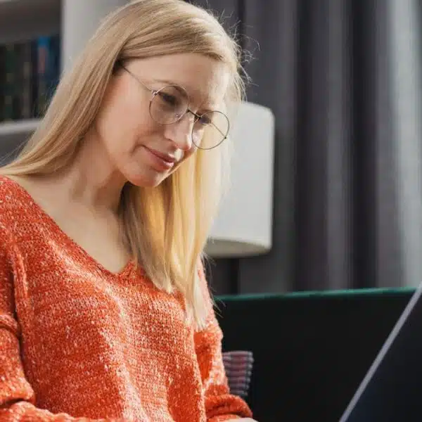 woman working on her laptop with her glasses