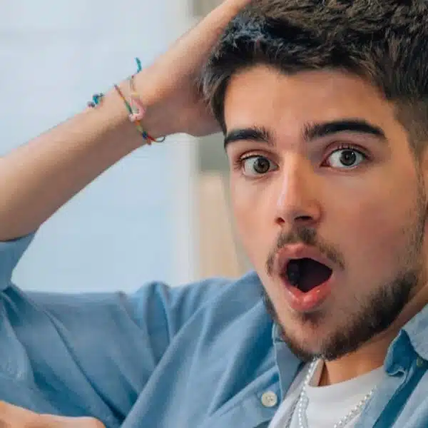 young man shocked reading his phone