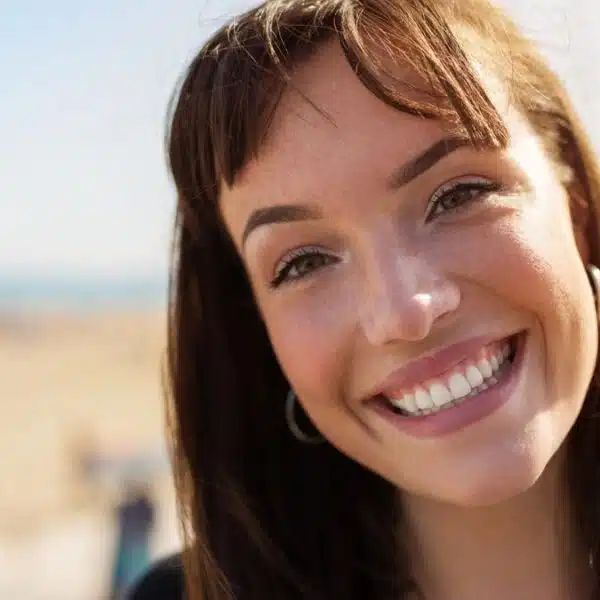 young woman smiling outside