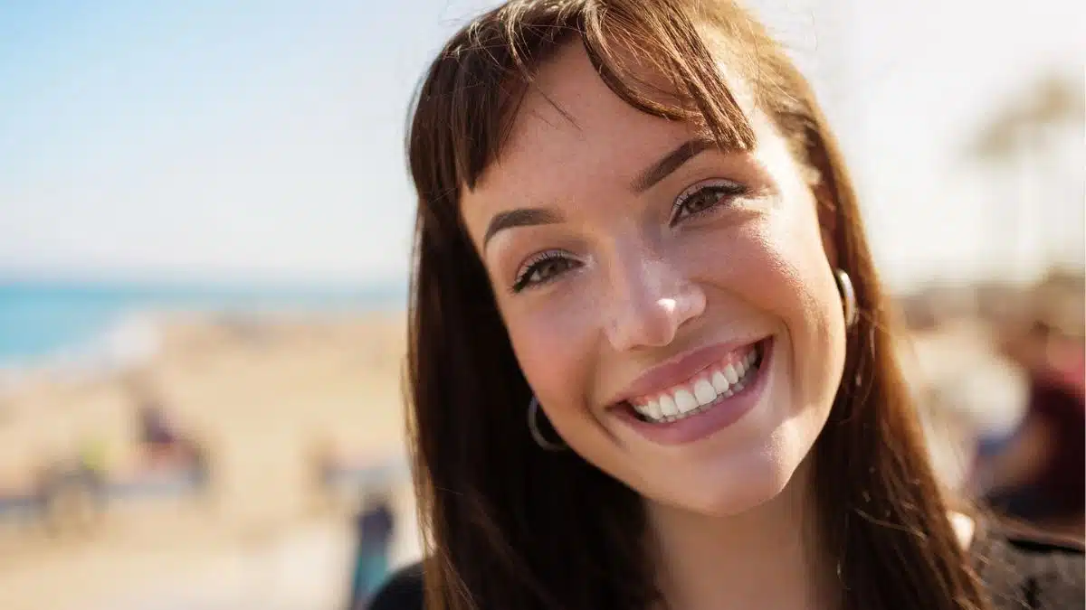young woman smiling outside