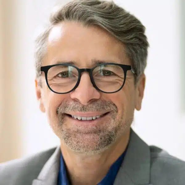 man glasses coat smile senior