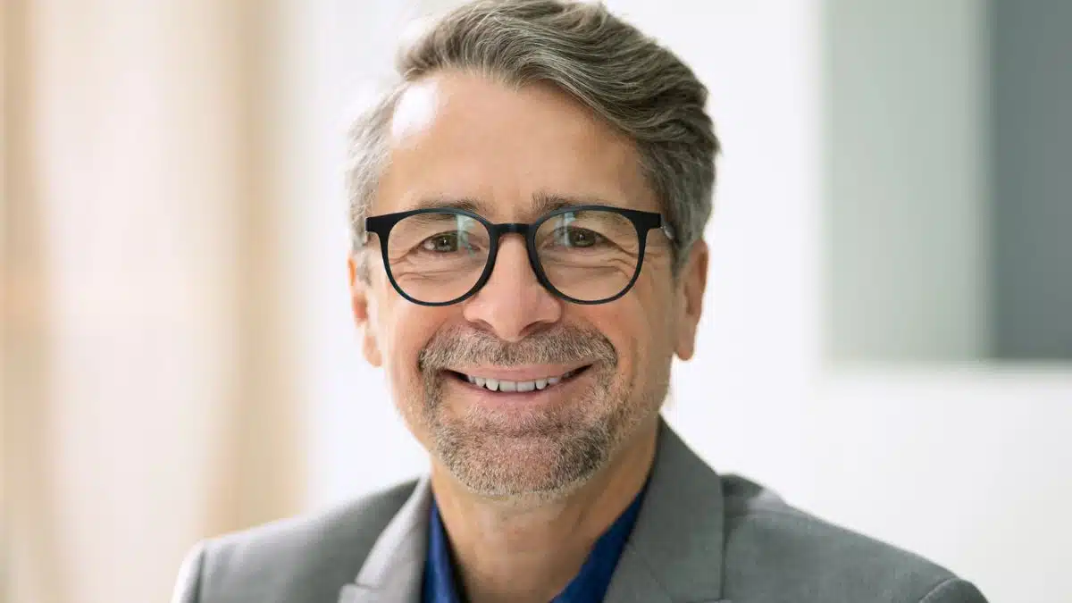 man glasses coat smile senior