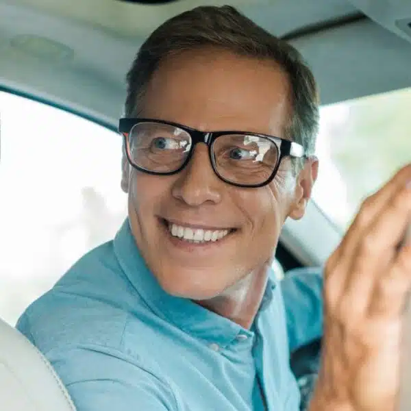 man over his shoulder in a car