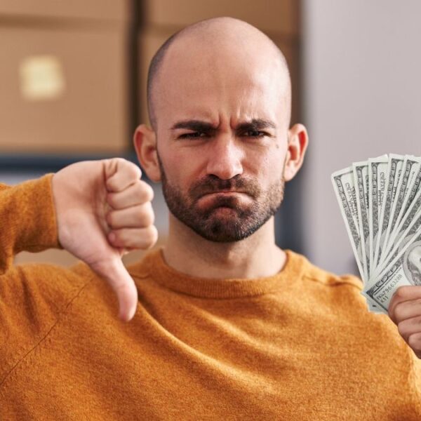man upset with money in hand