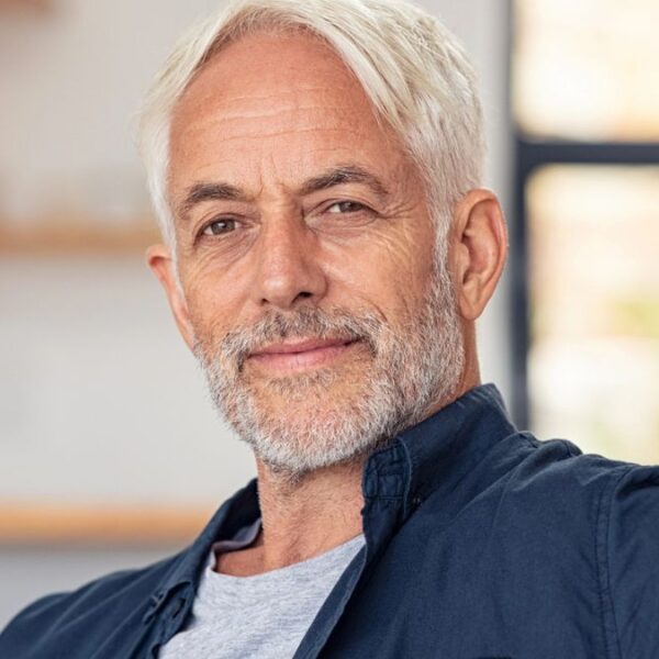 mature man sitting on the couch at home