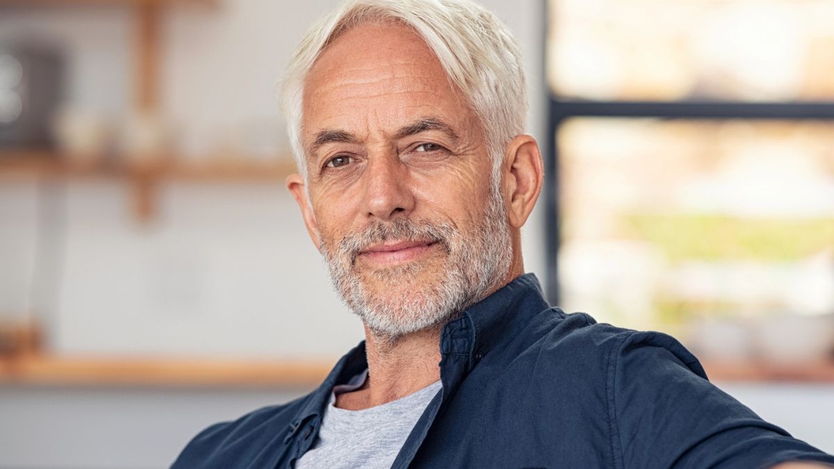 mature man sitting on the couch at home