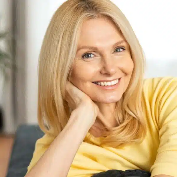 mature woman sitting on her couch