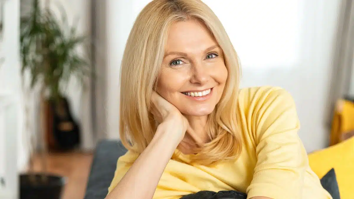 mature woman sitting on her couch