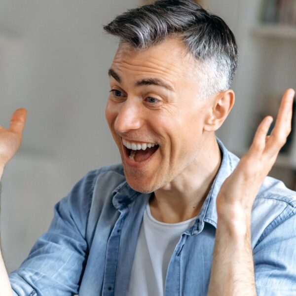 senior laughing at his laptop