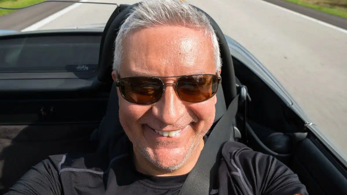 senior man driving a car on the road