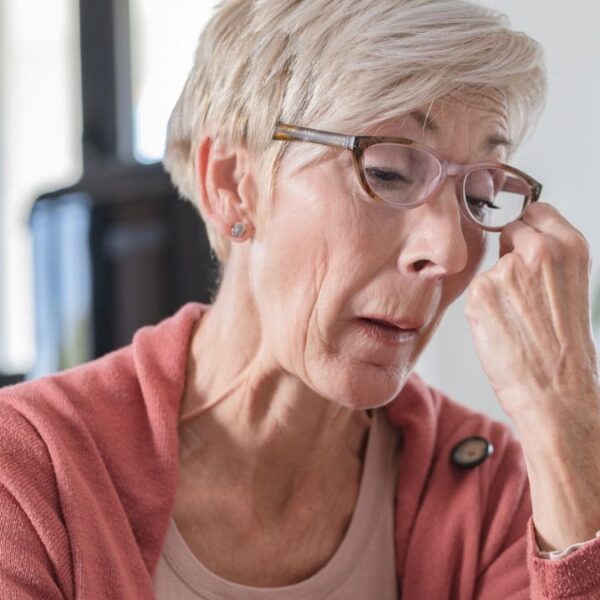 senior woman glasses crying at home