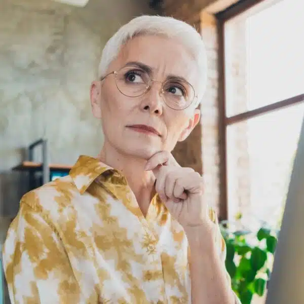 senior woman holding a laptop working
