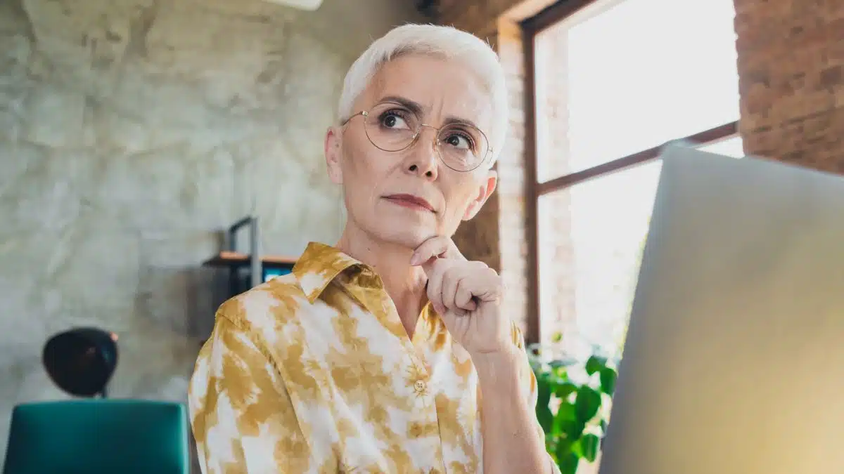 senior woman holding a laptop working