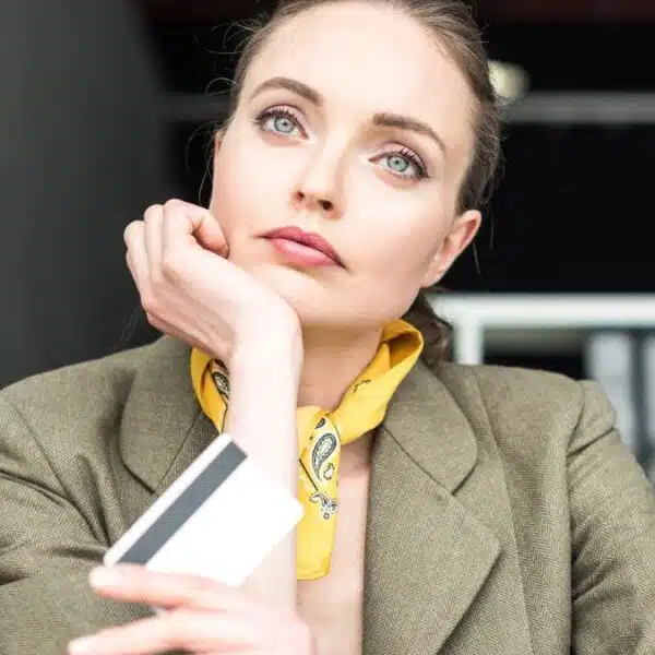 woman bored at desk with credit card