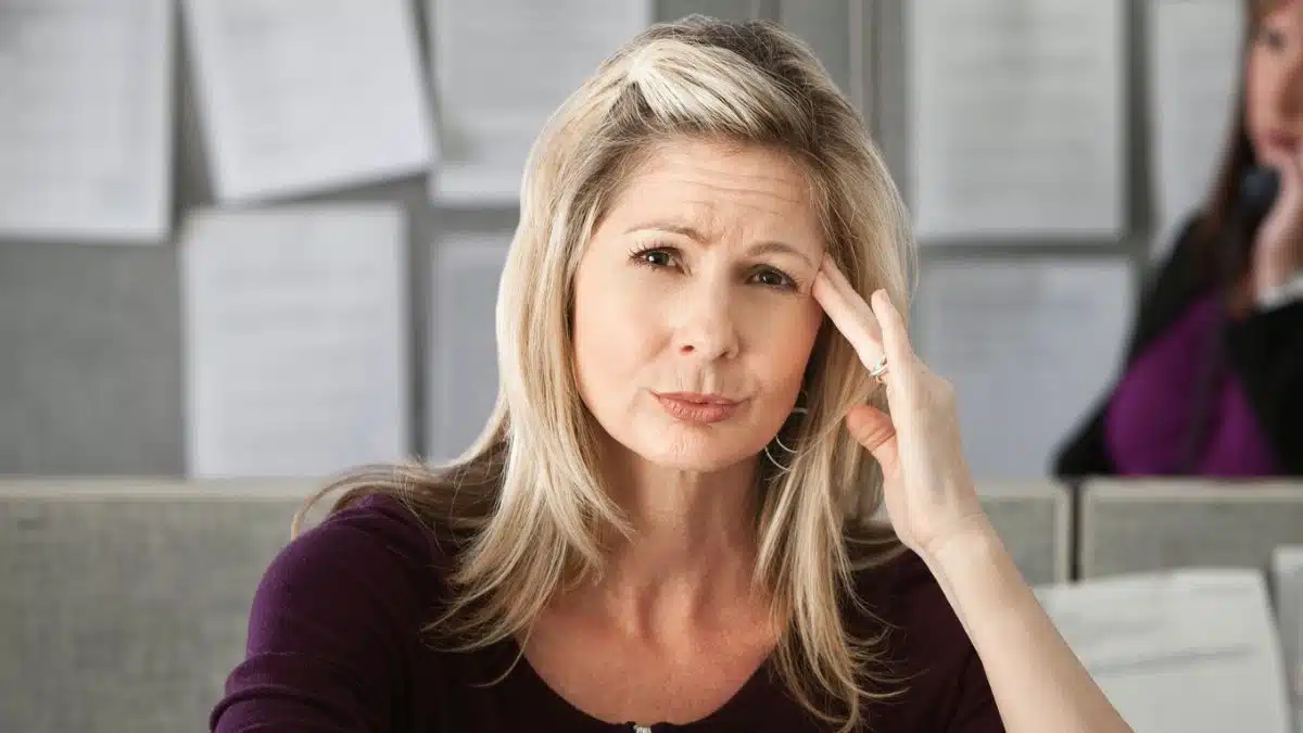 woman frown in the office cubicle
