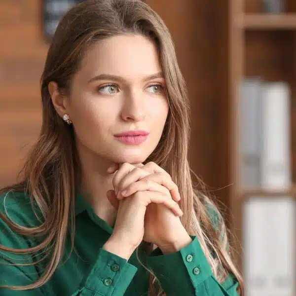 woman green short thinking in office