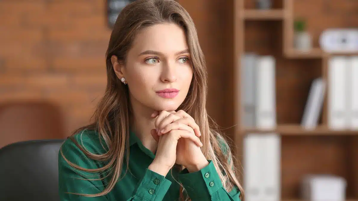 woman green short thinking in office