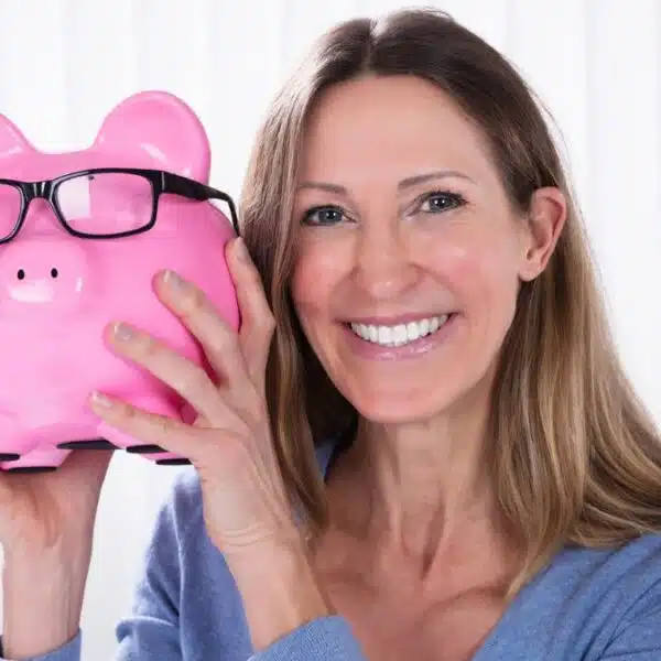 woman holding up a piggy bank