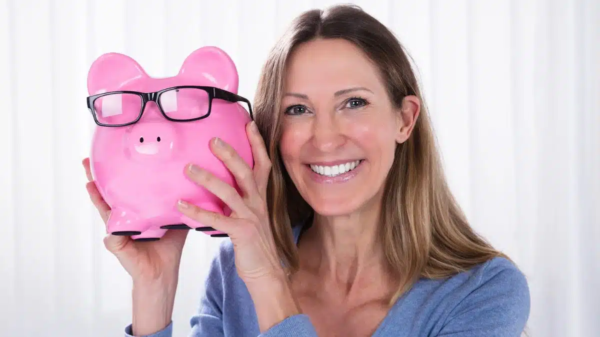 woman holding up a piggy bank