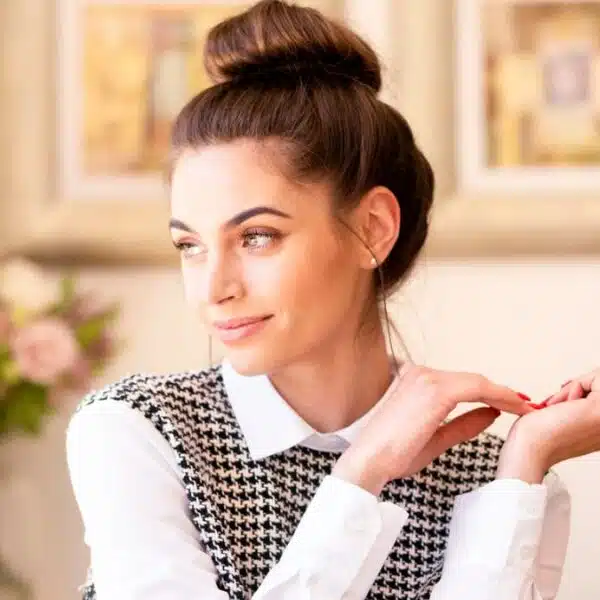 woman in a bun with glasses