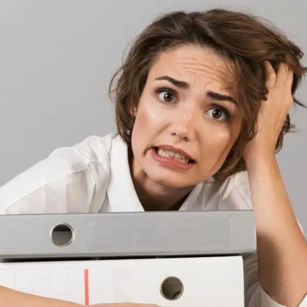 woman overwelmed at work with office folders