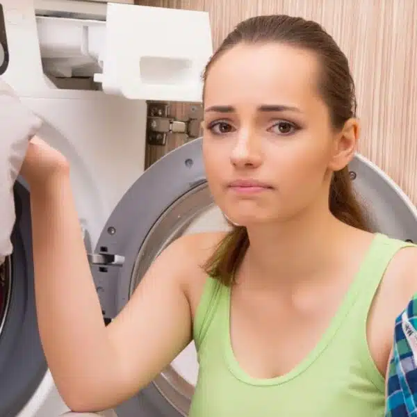 woman putting clothes in the laundry machine