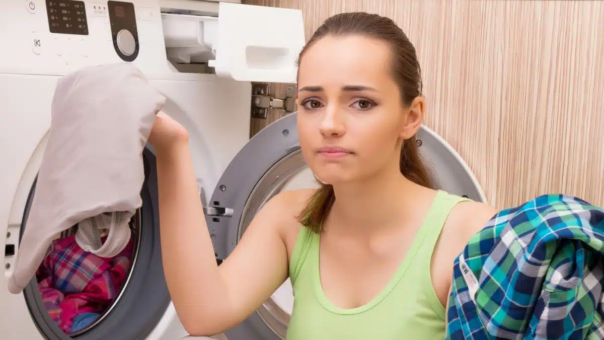 woman putting clothes in the laundry machine