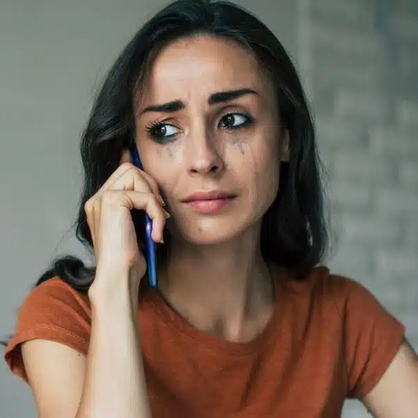woman sad crying tears phone