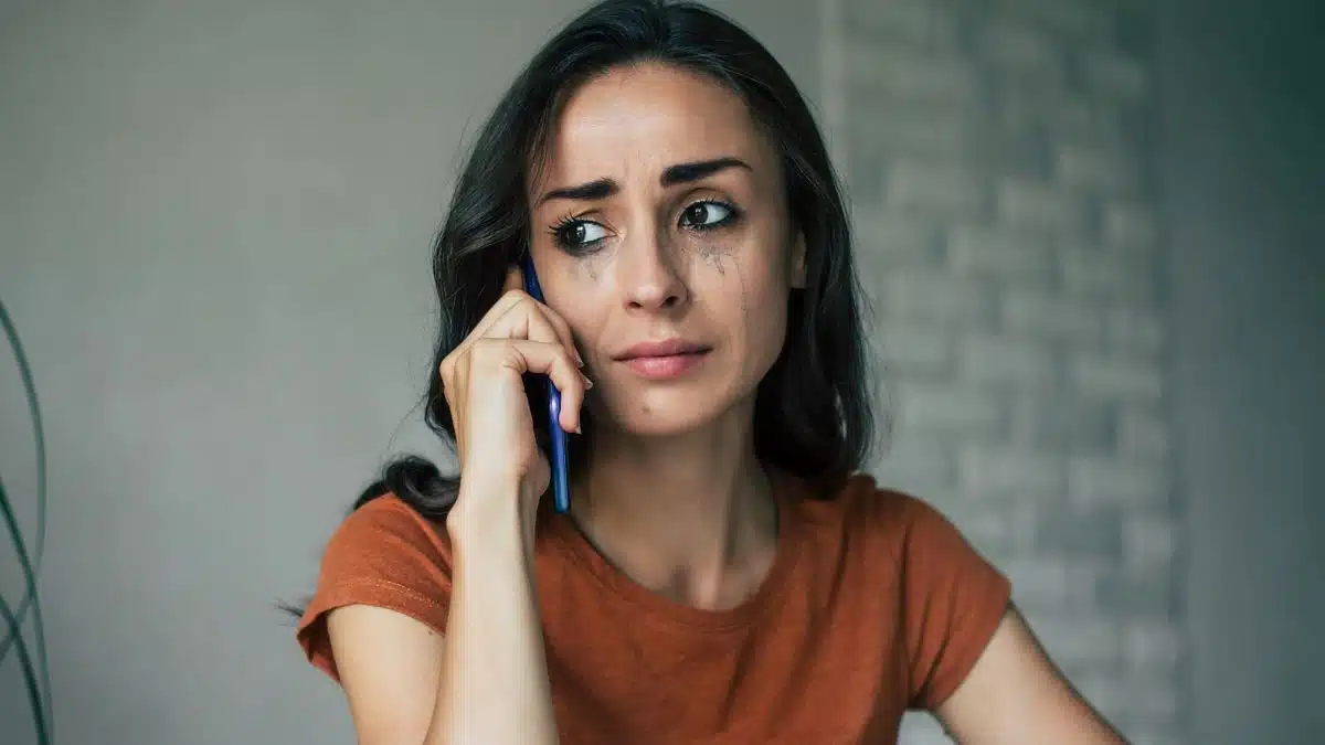 woman sad crying tears phone