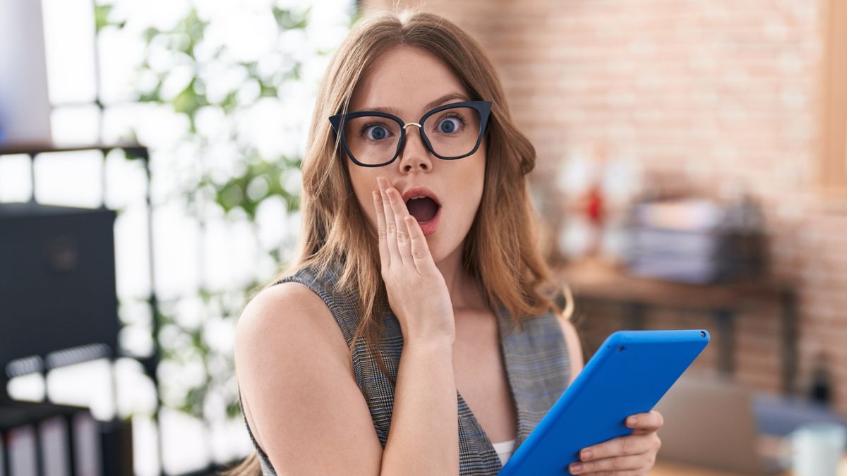 woman shocked glasses tablet