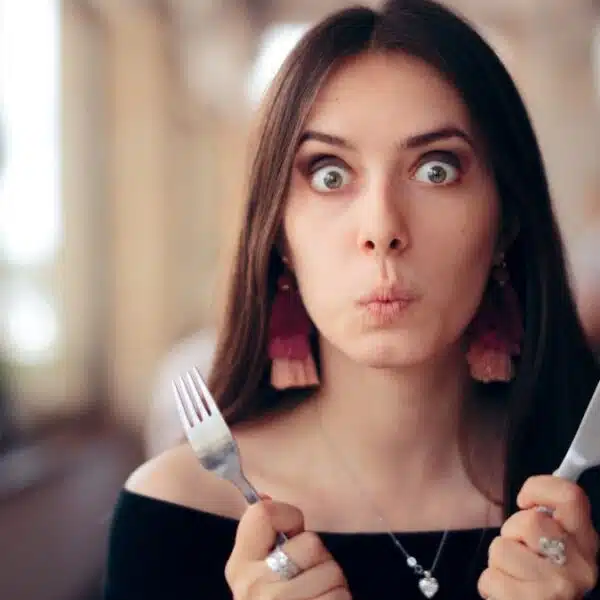 woman shocked with her food utensils
