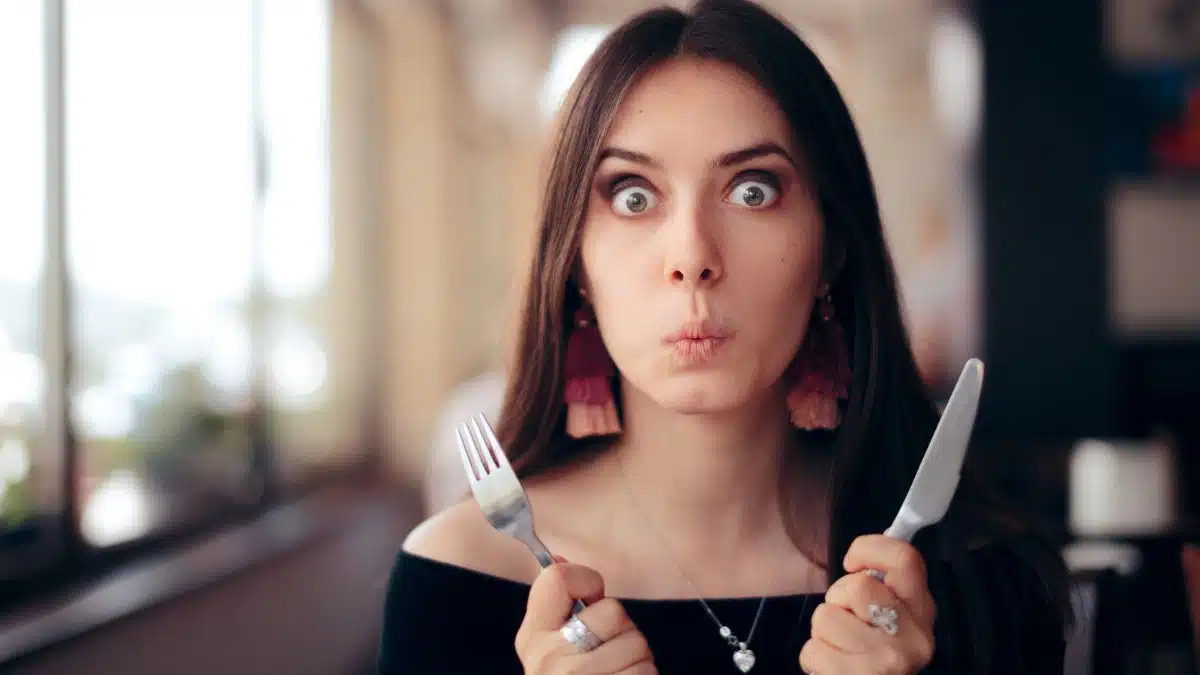 woman shocked with her food utensils