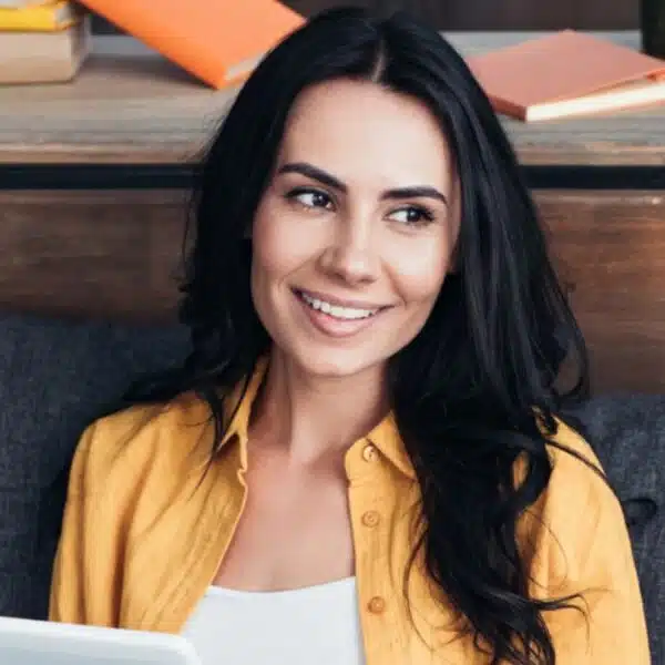 woman sitting on the couch happy