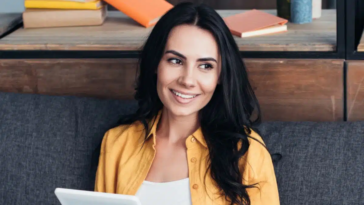 woman sitting on the couch happy