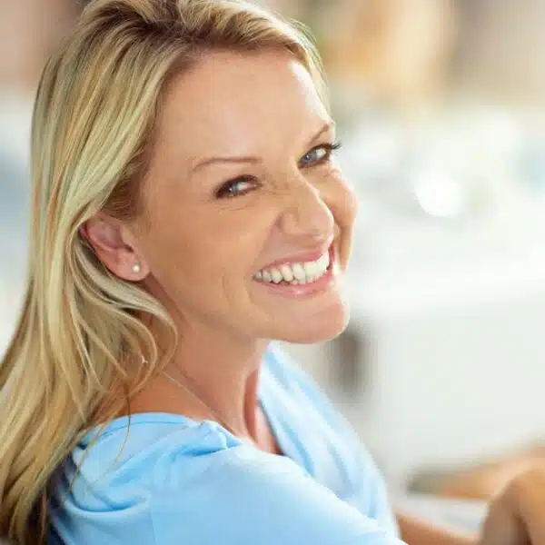 woman smiling on her couch