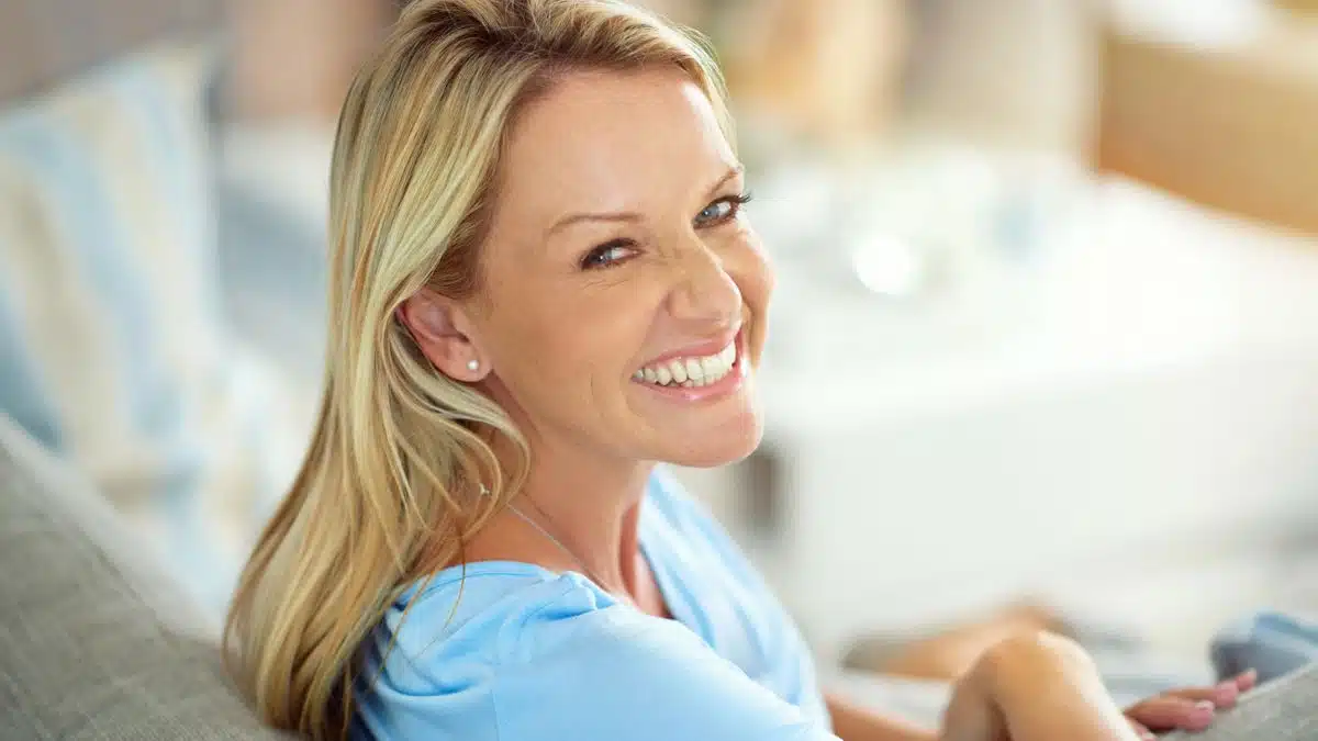 woman smiling on her couch