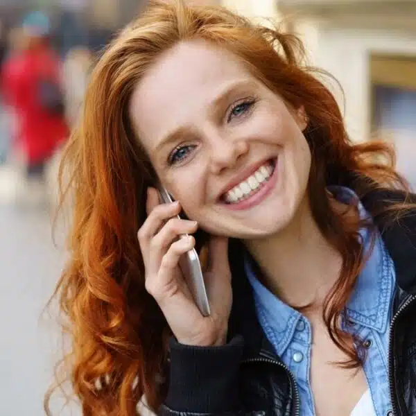 woman talking on her phone outside sitting (1)