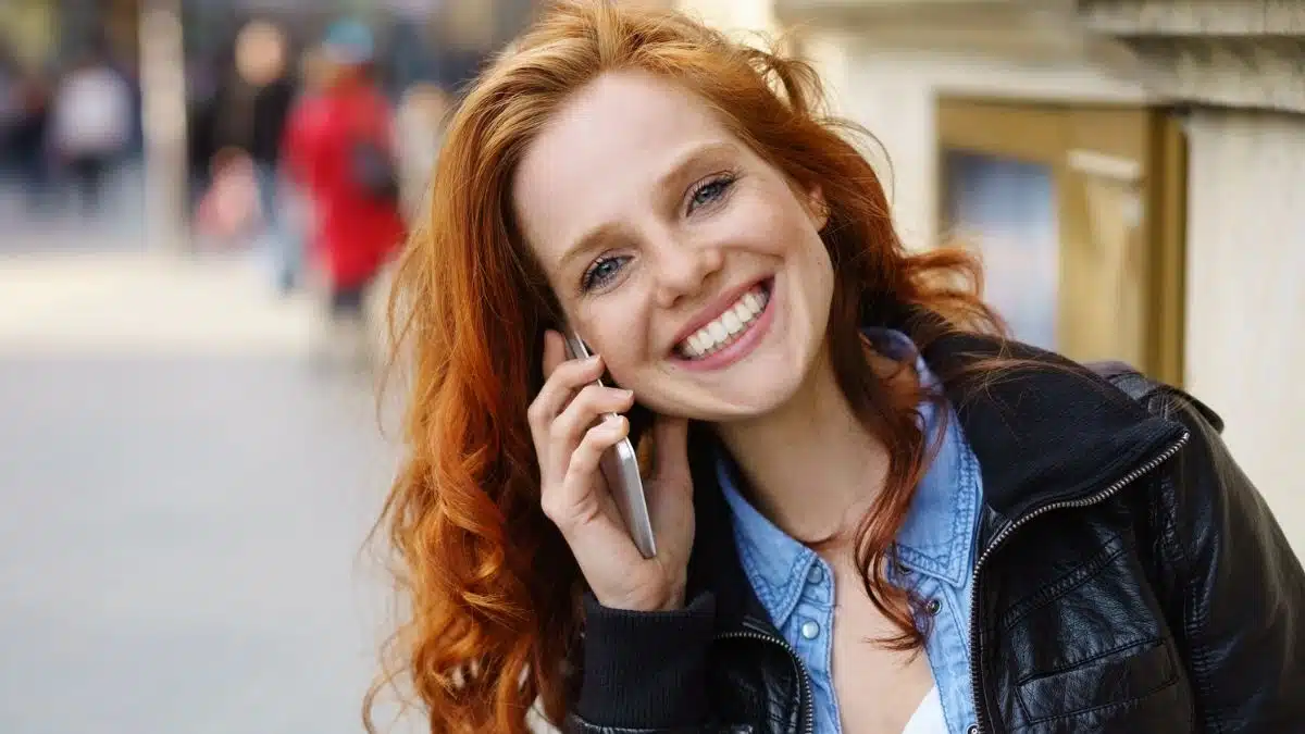 woman talking on her phone outside sitting (1)