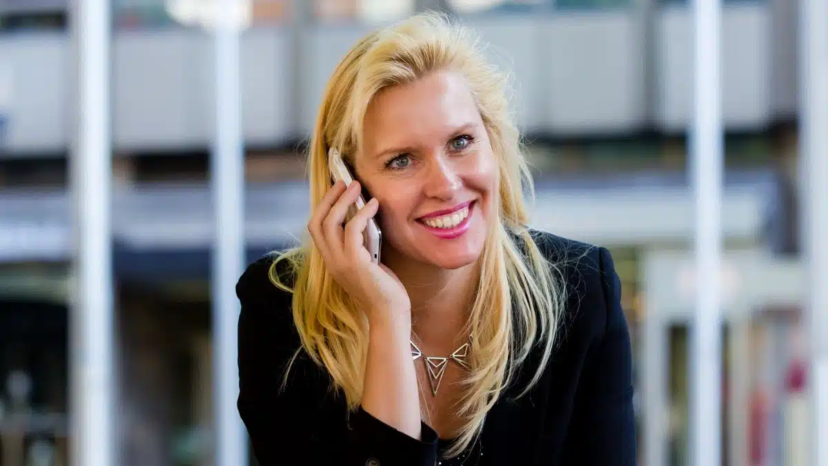 woman talking on her phone outside sitting
