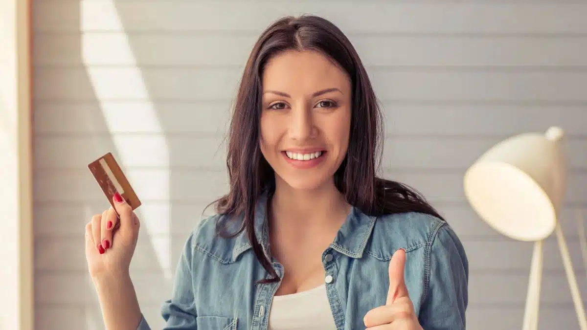 woman with her credit card and laptop at home