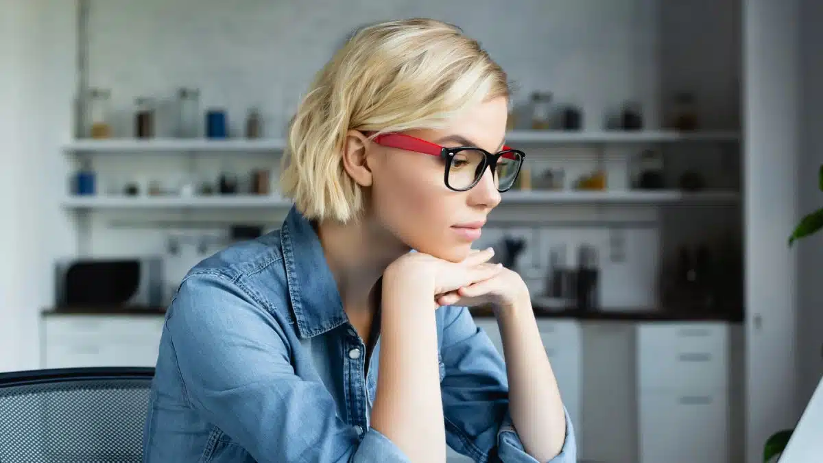 young woman glasses working at her desk