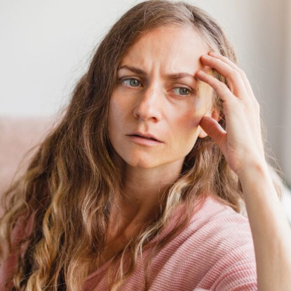 young woman worried looking out the window