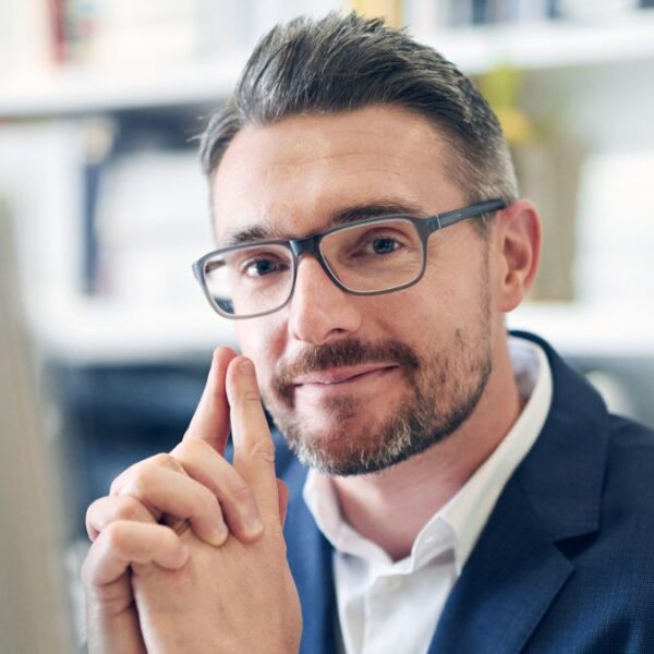 beard glasses sitting at laptop