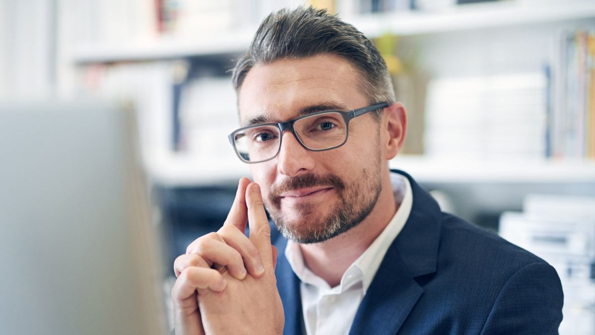 beard glasses sitting at laptop