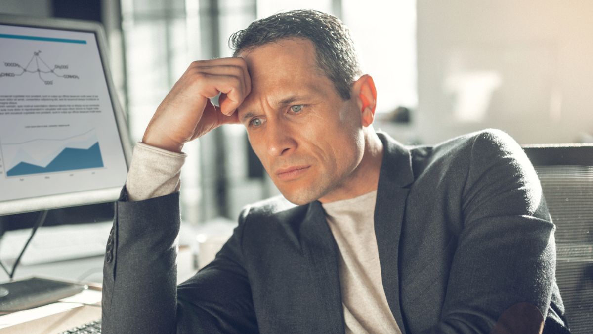 business sitting at desk with problems