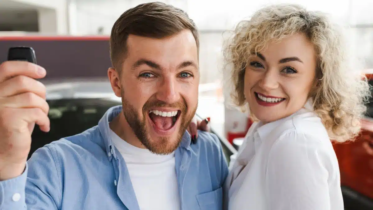 couple excited buying a car